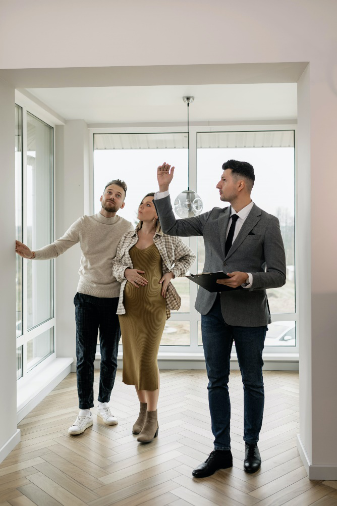 a real estate agent showing property to a couple