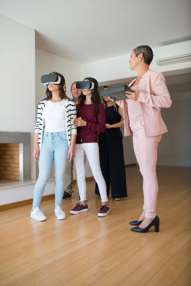 a real estate agent showing a house to a family through virtual reality goggles