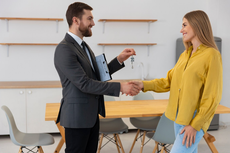 a real estate agent giving keys to a buyer